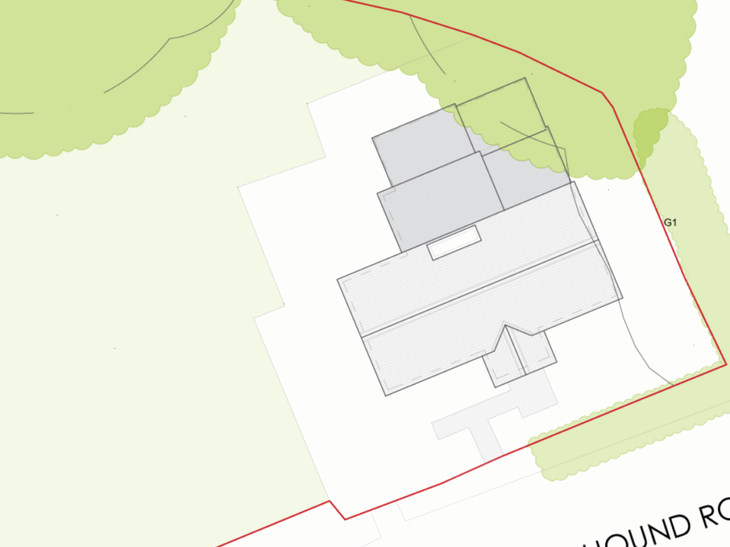 Existing site plan of the Victorian gate lodge on Hound Road, Netley Abbey, showing the lodge’s pitched roof and its rear lean-to additions within the red-lined plot, bordered by woodland.